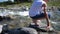 Mountain river. The guy is standing on a rock, the water flows around his feet and stone .Early morning traveler.