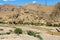 Mountain and river in Iran with orange rocks and desert around