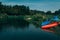 Mountain river landscape with two `resting` canoe on the bank