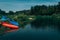 Mountain river landscape with two `resting` canoe on the bank