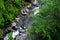 Mountain River rages on rocks on a sunny day