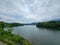 Mountain river in river valley. Summer river bank with blue sky and white clouds. River landscape in Kuala Kubu Baru, Malaysia