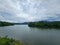 Mountain river in river valley. Summer river bank with blue sky and white clouds. River landscape in Kuala Kubu Baru, Malaysia