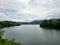 Mountain river in river valley. Summer river bank with blue sky and white clouds. River landscape in Kuala Kubu Baru, Malaysia