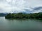 Mountain river in river valley. Summer river bank with blue sky and white clouds. River landscape in Kuala Kubu Baru, Malaysia