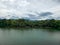 Mountain river in river valley. Summer river bank with blue sky and white clouds. River landscape in Kuala Kubu Baru, Malaysia