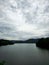 Mountain river in river valley. Summer river bank with blue sky and white clouds. River landscape in Kuala Kubu Baru, Malaysia