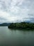 Mountain river in river valley. Summer river bank with blue sky and white clouds. River landscape in Kuala Kubu Baru, Malaysia