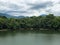 Mountain river in river valley. Summer river bank with blue sky and white clouds. River landscape in Kuala Kubu Baru, Malaysia