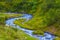 mountain river rushing among green valley