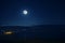 mountain river with stones and grass in the forest at the foot of mountain slope at night in moon light. Azerbaijan