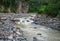 Mountain river with stones. Tropical landscape. Fresh river in stone riverbed.