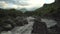 Mountain river stream landscape with dramatic cloudy sky