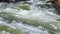 Mountain river water flow in powerful waterfall, video background.