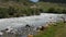 Mountain river with water stream and stones in canyon valley