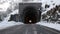 Mountain road with ancient stone tunnel in winter scenic