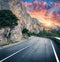 Mountain road and beautiful sky at sunset. Colorful landscape