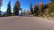 Mountain road drive during a wonderful autumn day. Colorful trees and blue sky.