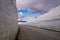 Mountain road with high snow wall