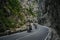 The mountain road runs between the rocks in the Romanian Carpathians