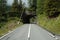 Mountain road and short tunnel in Alps in Switzerland