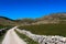 A mountain road surrounded by rocks. Mountain hills in the background