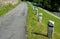 Mountain road with traditional white stone bollards with a black stripe. Old stone pillars of granite stone perched on the lawn