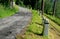 Mountain road with traditional white stone bollards with a black stripe. Old stone pillars of granite stone perched on the lawn by