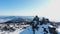 Mountain rocky peak covered with snow against pine forests