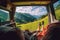 Mountain scenery view as seen from inside a campervan, with legs and a cup of coffee visible in the foreground. Ai generated