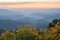 Mountain scenery with yellow flowers meadows in springtime morning sunrise.mountain range with fog and clound in chiangrai north