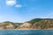 Mountain seascape. Turquoise water, pine mountains and blue skies.