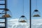 Mountain-shaped lamps hang inside a restaurant opposite a snow-capped mountains window in Austrian Alps.Selective focus on lamps