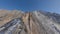 Mountain sharp texture cinematic ridge summit altitude with snow blue sky glare aerial view
