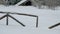 Mountain Shelter behind a Wooden Fence in a Deep Snow Covered Winter Landscape