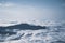 Mountain silhouette above the clouds at sunrise, view from the top view of mountains.