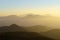 Mountain silhouettes at sunset with haze