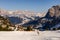 Mountain ski slope. Italian alps. Skiers enjoying last remaining bits of snow in melting late summer weather.