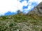 Mountain slope covered in rock rubble and yellow flowers