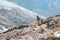 Mountain Slope and Group of Climbers walking on Footpath