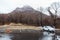 Mountain with snow and fog on the top and trees below at carpark of Noboribetsu Bear Park in Hokkaido, Japan