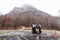 Mountain with snow and fog on the top, trees and guard house below at carpark of Noboribetsu Bear Park in Hokkaido, Japan