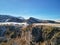 a mountain with some snow on the side of it and a blue sky above