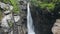 Mountain spring stream high waterfall in forest