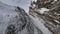 Mountain stone summit speed dive rocky texture winter valley frozen cinematic landscape aerial view