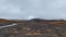 Mountain stream on burnt ground, beautiful autumn tundra, hills and lava plains with black volcanic sand