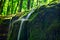 Mountain stream in the sun on a long exposure with beautiful tracks from falling drops.