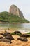 Mountain Sugarloaf and fishing rod on red beach in rainy day, Ri