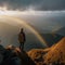 Mountain Summit Serenity: Hiker Captures Breathtaking Valley View and Rainbow During Golden Hour