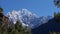 Mountain Thamserku in the Himalayas seen from Mount Everest Base Camp Trek near Manjo, Nepal framed by coniferous trees.